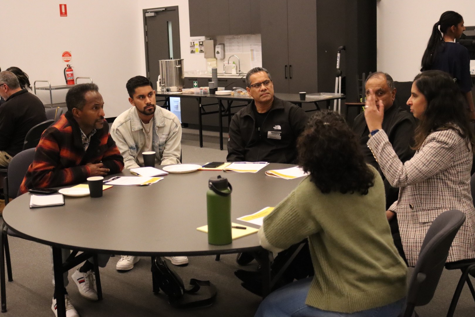 Community members sharing a conversation around a table